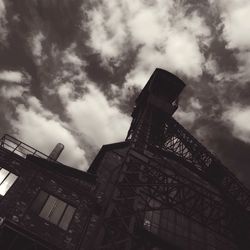 Low angle view of building against cloudy sky