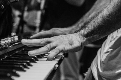 Close-up of man playing piano