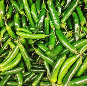 Full frame shot of green chili peppers for sale in market