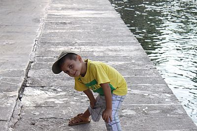 High angle view of smiling boy on footpath