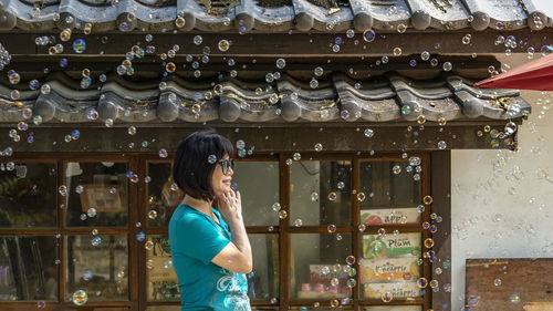 Full length of woman looking at store