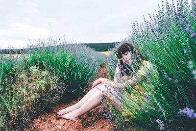 Woman sitting on grassy field