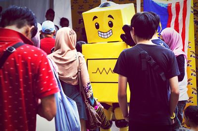 Rear view of people standing outdoors