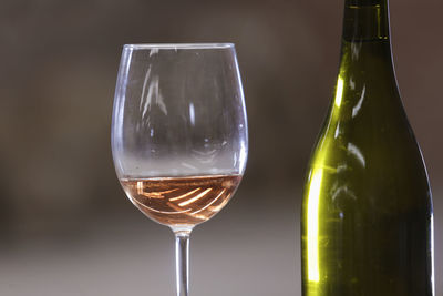 Close-up of wineglass and bottle