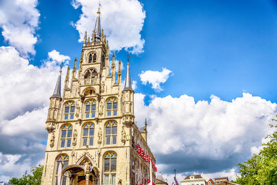 Low angle view of church against cloudy sky