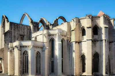 Low angle view of historical building against clear blue sky