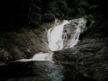 Close-up of water splashing against black background