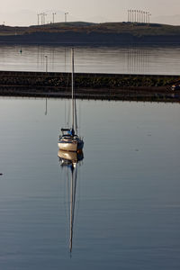 Sailboat in sea against sky