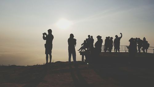 Silhouette of people at sunset