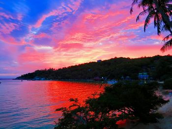 Scenic view of sea against romantic sky at sunset