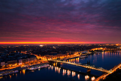 Illuminated bridge over river at night