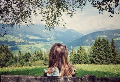 Rear view of girl looking at mountains