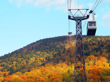 Low angle view of tower against sky during autumn