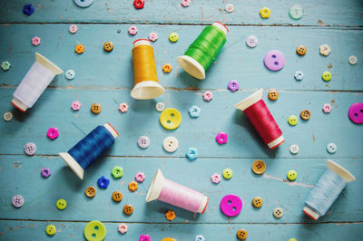 High angle view of multi colored buttons on table