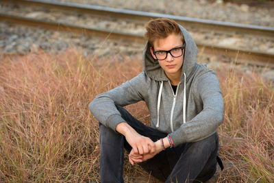 Young man sitting on floor