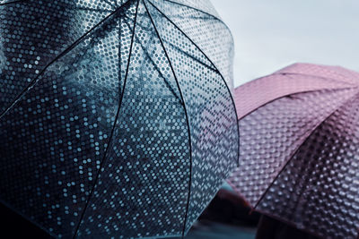 Close-up of umbrella against sky