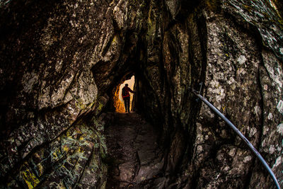 Rear view of woman in cave