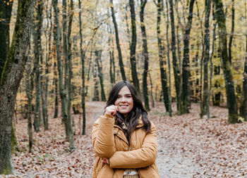 Portrait of a beautiful young woman, autumn, forest, outdoors.