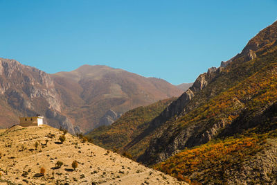 Scenic view of mountains against blue sky