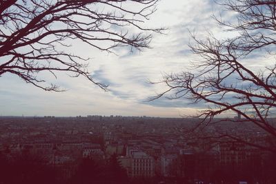 Buildings against cloudy sky