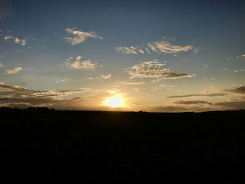 Silhouette landscape against sky during sunset