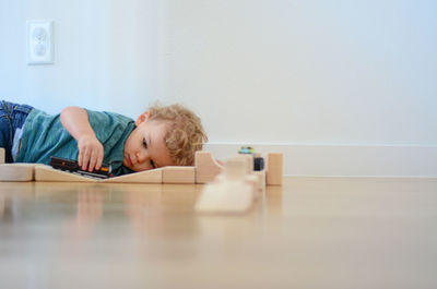 Portrait of boy sitting on floor at home