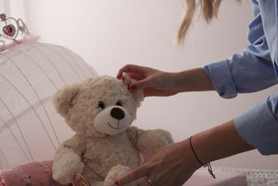 Midsection of woman with stuffed toy