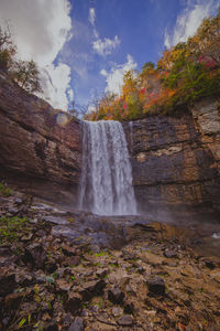 Scenic view of waterfall against sky