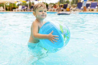 Portrait of young woman swimming in pool