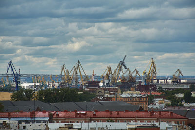 Commercial dock against cloudy sky