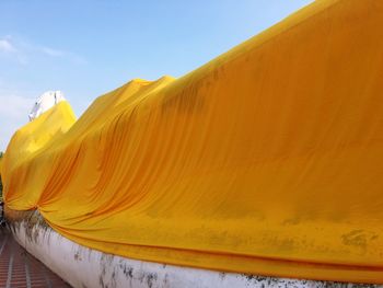 Reclining buddha against sky