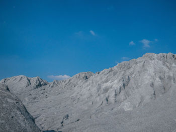 Scenic view of desert against blue sky