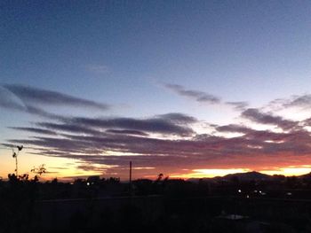 Silhouette landscape against scenic sky