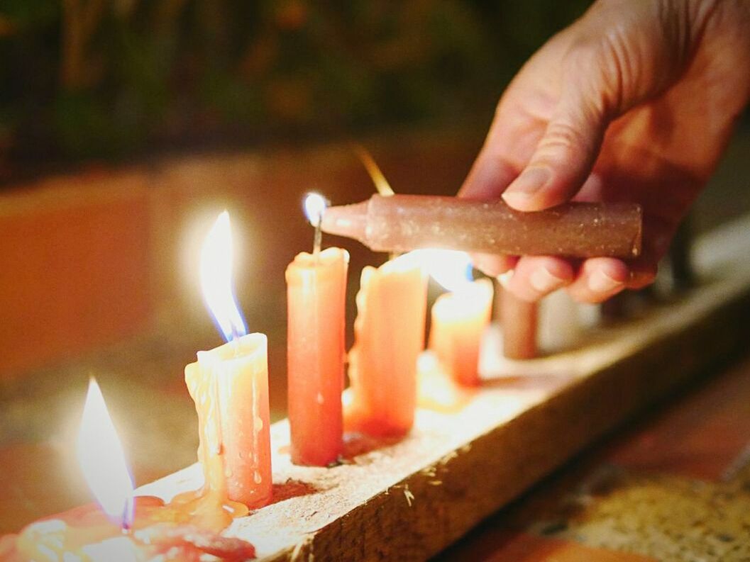 flame, burning, heat - temperature, person, fire - natural phenomenon, indoors, part of, close-up, holding, candle, preparation, selective focus, focus on foreground, cropped, food, food and drink, preparing food