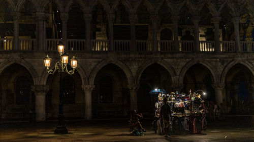 Group of people in illuminated building at night