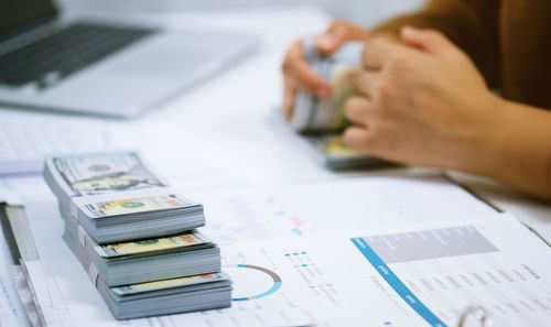 Midsection of business colleagues working on table