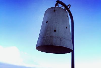 Low angle view of metal against blue sky