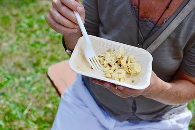 Midsection of man eating food