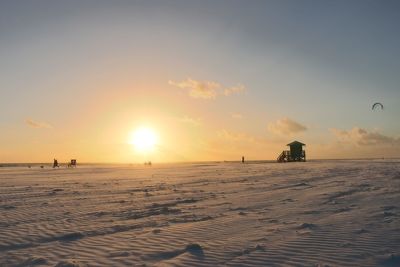 Scenic view of beach against sky during sunset