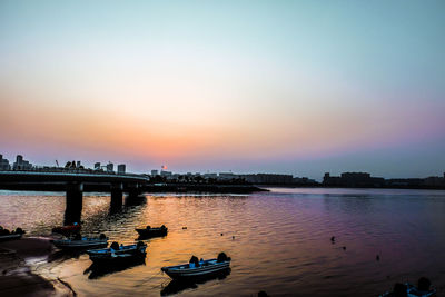 Scenic view of river against sky during sunset