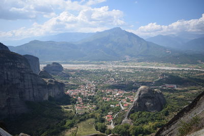 Aerial view of buildings and mountains against sky