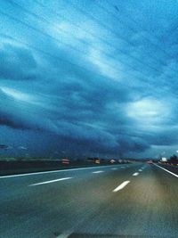 Close-up of cars on road against sky