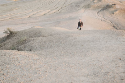 Man walking on arid landscape