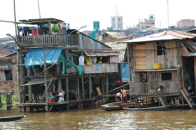 Boats in canal amidst buildings in city