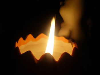 Close-up of illuminated hand in darkroom