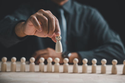 Cropped hand of man playing chess