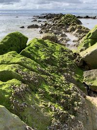 High angle view of rocks on beach against sky