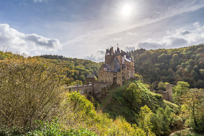 Panoramic view of trees and buildings against sky