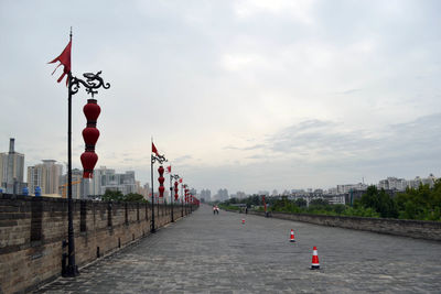 City street by river against sky