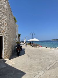 Scenic view of beach against clear blue sky